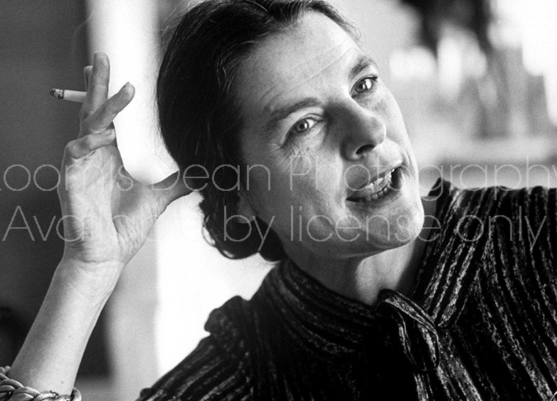 Closeup of Novelist, Mary McCarthy w. cigarette in hand propped against her head, talking candidly at her apartment, Paris, France.