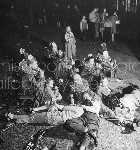 Maskers taking a break during Mardi Gras.