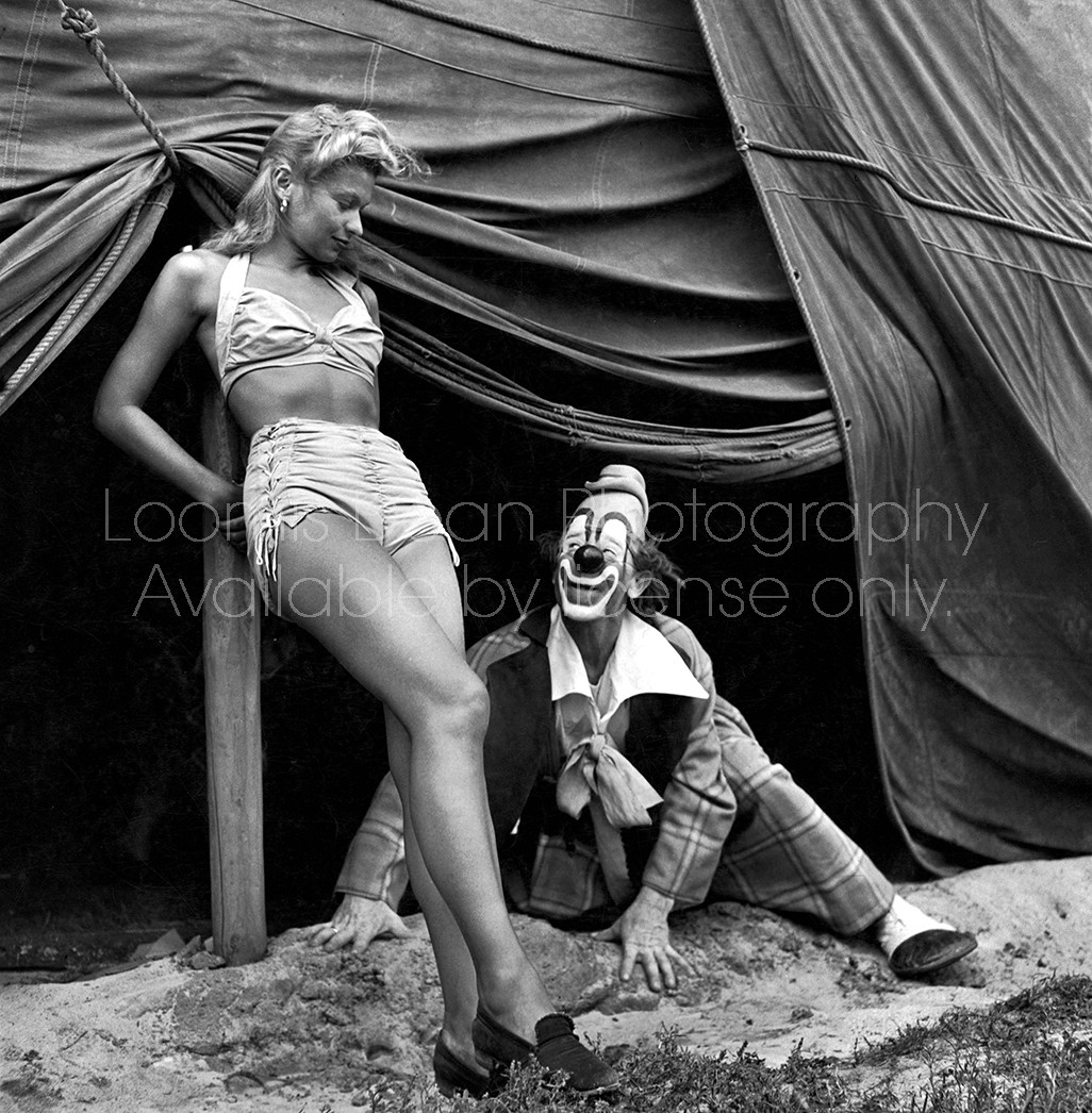 Star clown Lou Jacobs looking up at a showgirl.