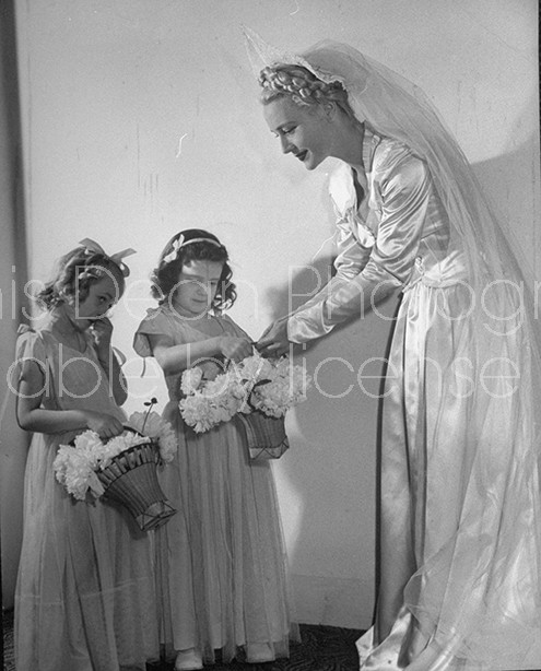 Bride standing with flower girls at West Point wedding ceremony.