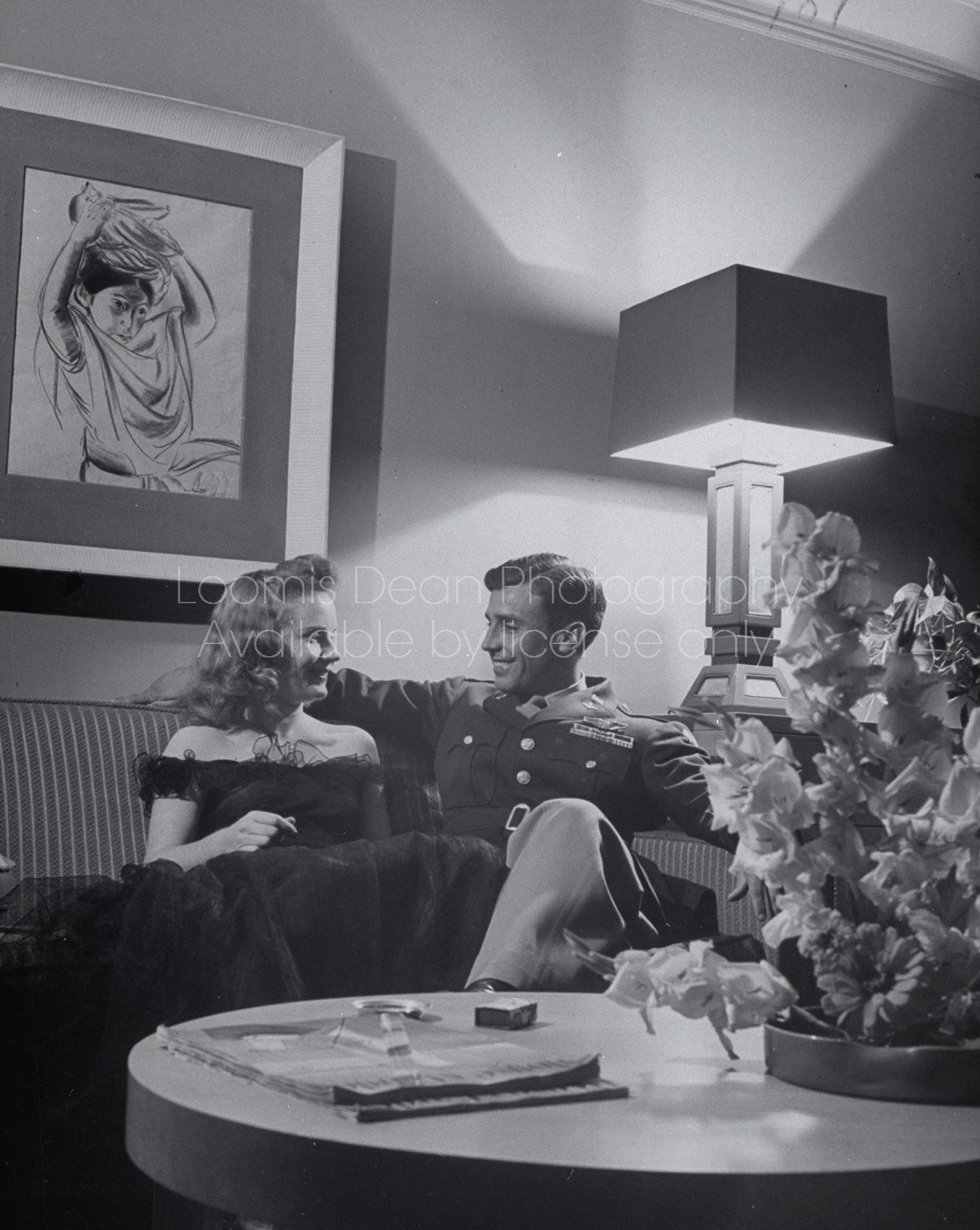 Couple sitting on sofa.