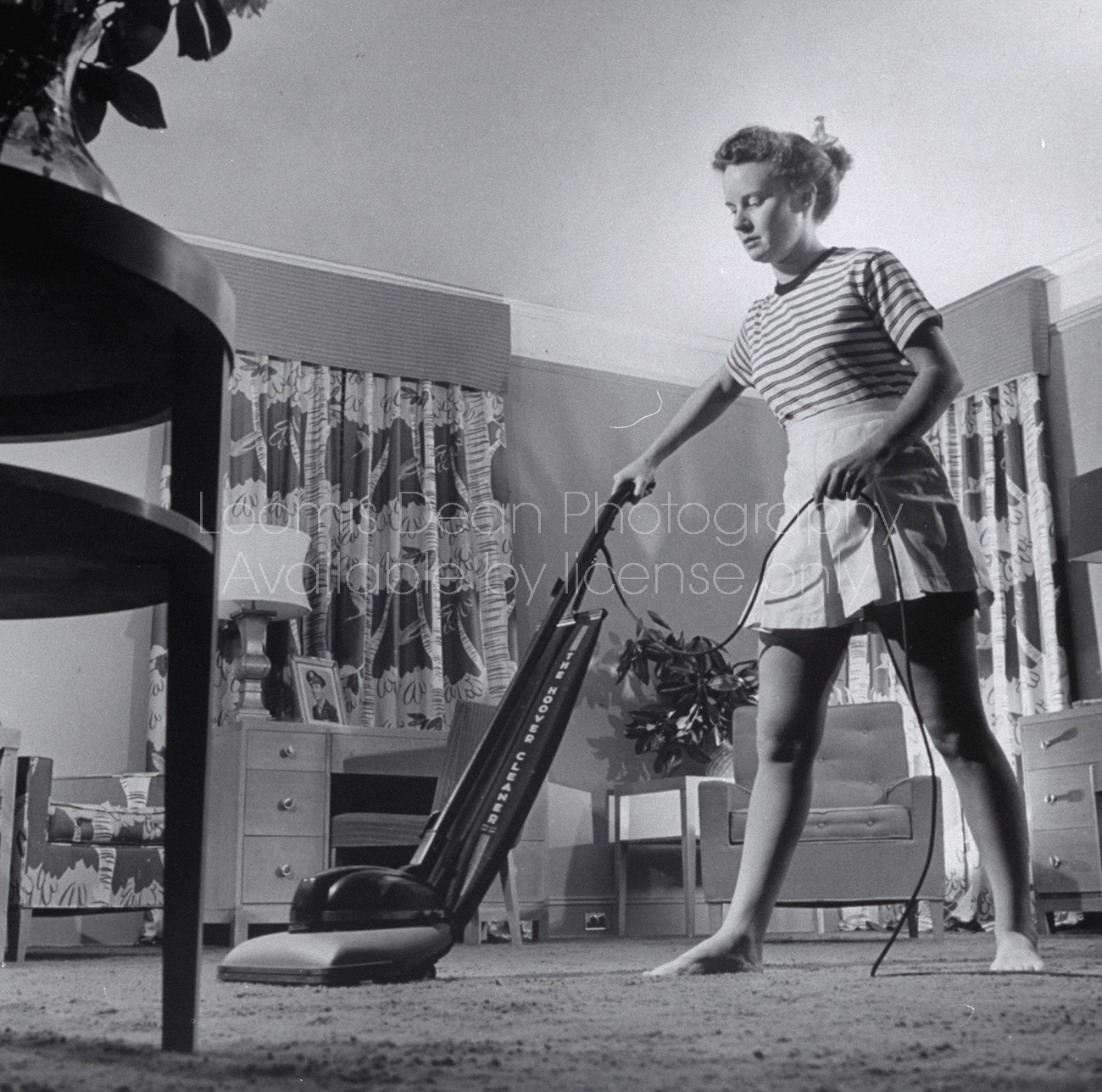 Woman vacuuming.
