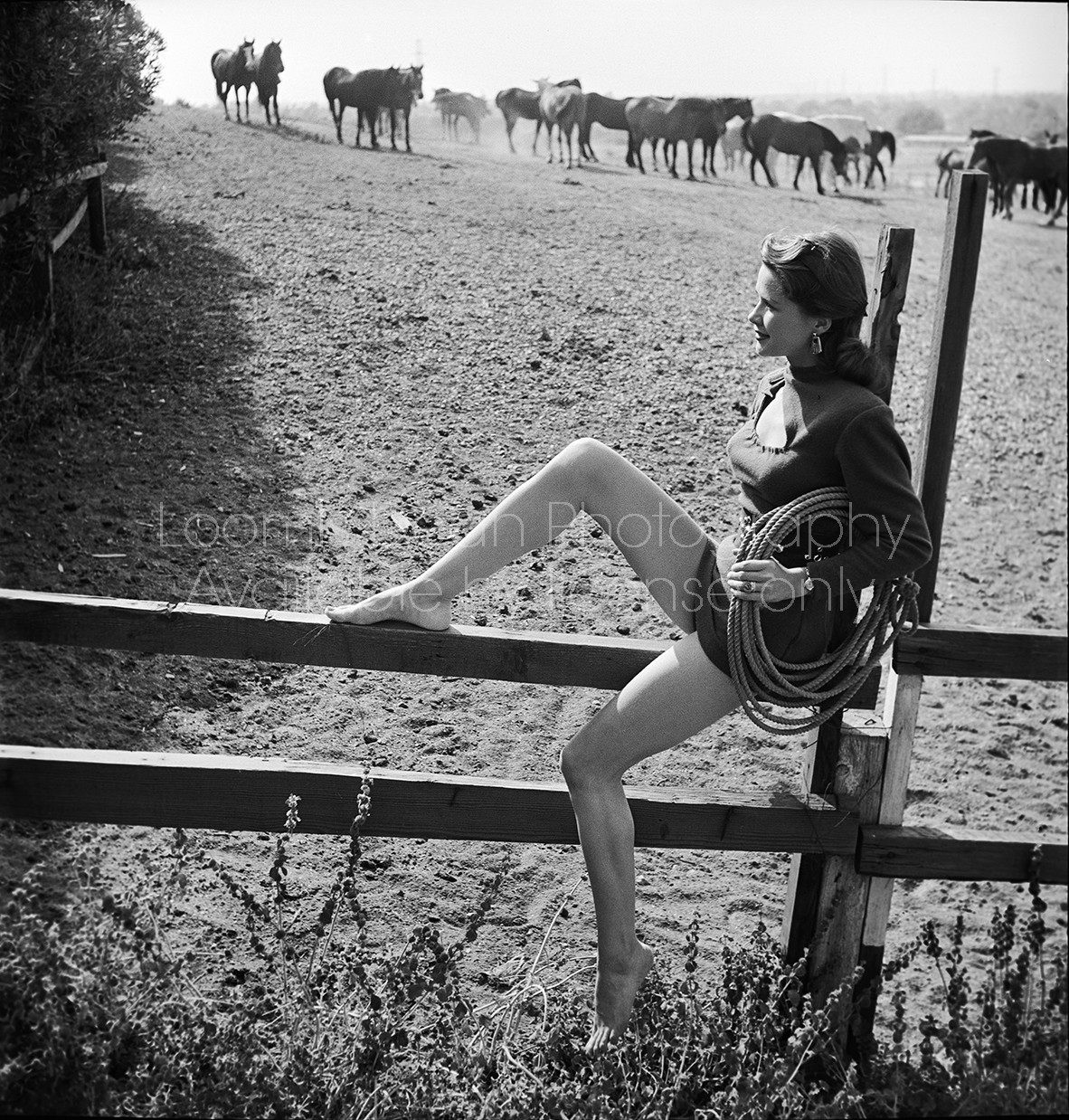Lucille Barnes sitting on wooden fence in "Two Guyes From Texas."