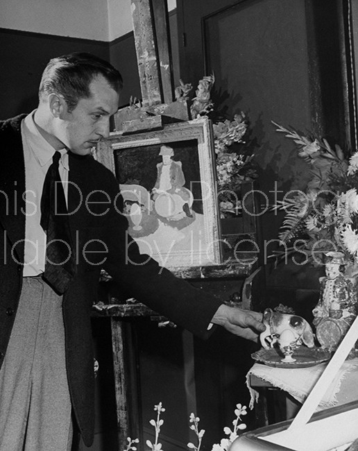 Actor Vincent Price arranging unfinished still life.