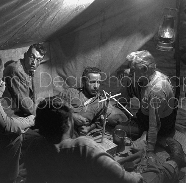Director of "The Treasure of the Sierra Madre" John Huston (L) with the film's actors Humphrey Bogart (C), his father Walter Huston and two unident. others as they talk inside of lamplit tent.