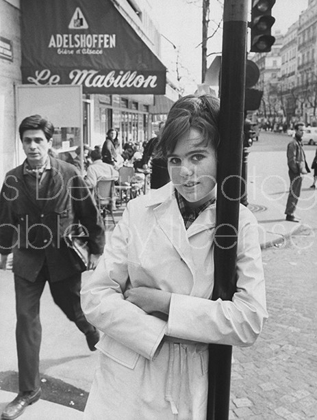 Eighteen year old novelist Caroline Glyn standing outside French cafe satirized in her book "Love and Joy in the Mabillon."