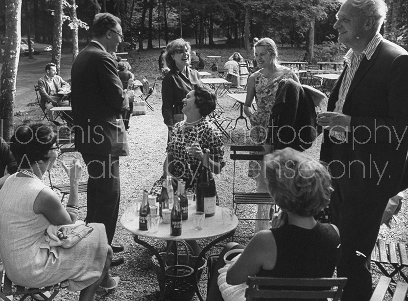Poet Stephen Spender (R), Mrs. George Orwell (C, standing) and poet Robert Lowell (2L, standing) attending a picnic.