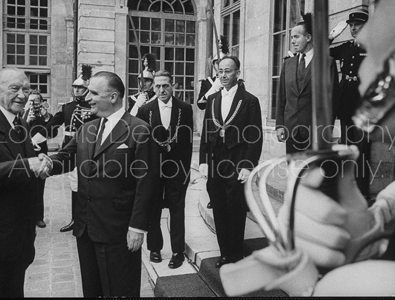 French Premier Georges Pompidou (2L) greeting Konard Adenauer (L) on his visit to France.