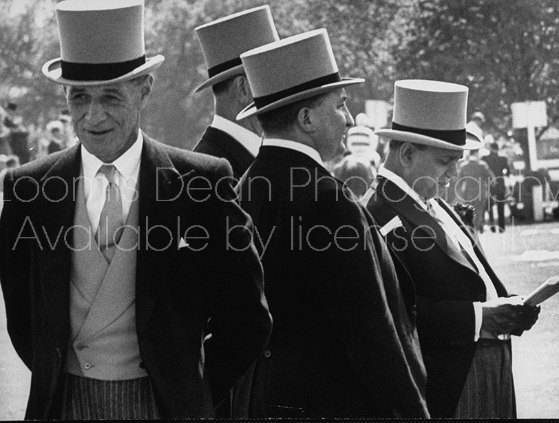 Britain's "Old Etonians" in distinctive top hats, attending the races.