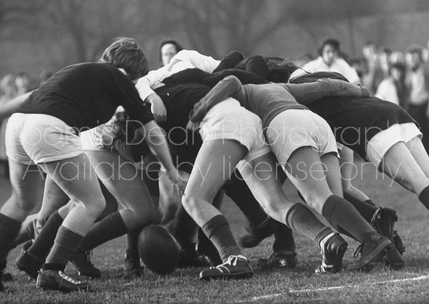 Girl's rugby team from Edinburgh University doing a scrum during a game.