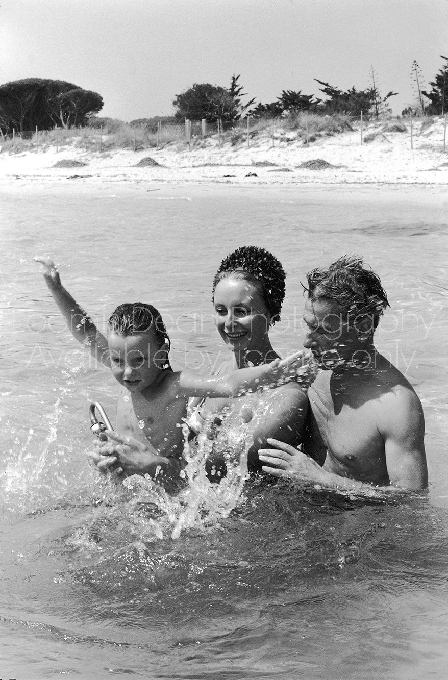 Conductor Herbert von Karajan (R) playing in the water with wife Eliette and daughter Isabelle.  [Scanned from contact sheet.]