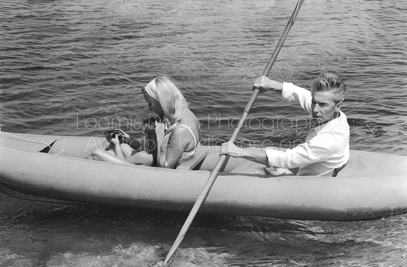 Conductor Herbert von Karajan (R) rowing an inflatable raft with wife Eliette and daughter Isabelle. [Scanned from contact sheet.]