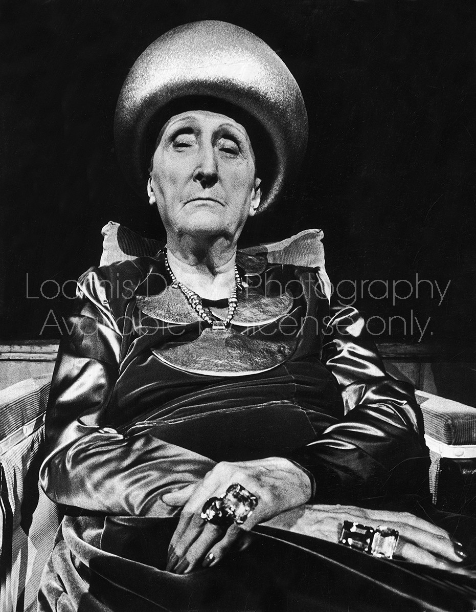 Portrait of poetess Dame Edith Sitwell sitting in wheelchair, awaiting rehearsal for her 75th birthday concert and poetry reading at Royal Festival Hall. 