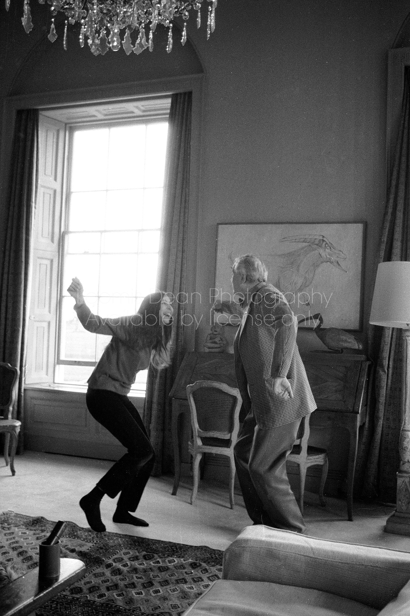(L-R) Teenage actress Anjelica Huston dancing with her father, director John Huston, at their home.