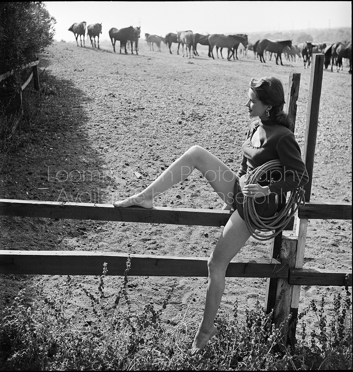 Lucille Barnes sitting on wooden fence in "Two Guyes From Texas."