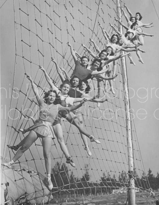 CIRCUS ACROBATS POSING ON A ROPE LADDER 