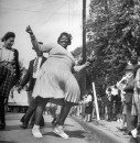 African American woman joyfully dancing during zulu parade during Mardi Gras.