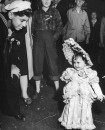 A very little girl dressed as a "Southern Bell" during Mardi Gras.