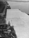 US aircraft carriers swathed in tarred down cotton sheeting to preserve and seal the hull in a storage depot waiting for reuse.