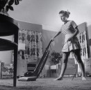 Woman vacuuming.