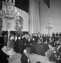 Miguel Aleman wearing suit and tie during his inauguration, talking to those gathered.