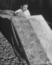 A man working with hand blocked fabrics made by tillets.