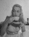 Nightclub singer Joan Nichols drinking a cup of coffee.