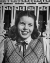 Co-ed student wearing ribbon tie, adding favorable touch to white blouse.