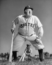 Pirates baseball player Honus Wagner standing and holding baseball bat.