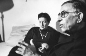 Writer Simone de Beauvoir chatting with close friend, playwright Jean Paul Sartre in her Paris apartment.