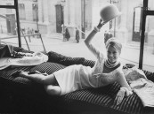 Actress Jane Fonda reclining in the window of a Paris fashion boutique.