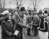 Jockey Pat Taaffe (R), and Gregory Peck and wife (L), talking at the Grand National.