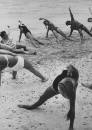 Members of French vacation Club Mediterranee doing exercises on the beach.