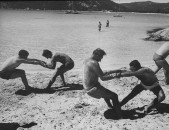 Members of French vacation Club Mediterranee doing exercises on beach.