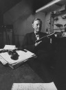 British mystery writer Ian Fleming at Gunsmiths, Coopwell and Harrison holding a .22 Ruger Mark I target pistol.