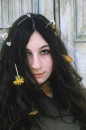 Closeup of actress Angelica Huston w. flowers in her hair.