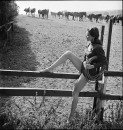 Lucille Barnes sitting on wooden fence in "Two Guyes From Texas."