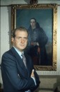 Spanish Prince Juan Carlos posing in front of portrait of his grandfather King Alphonso XIII, at home outside Madrid.