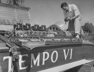 Bandleader Guy Lombardo working on his motorboat.