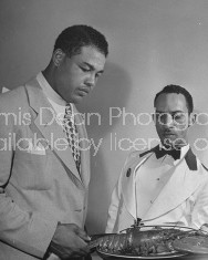 Waiter serving Joe Louis at Louis' restaurant.