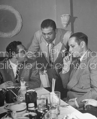Boxer Joe Louis with patrons at his restaurant.