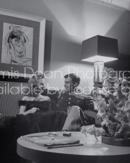 Couple sitting on sofa.