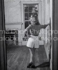 Woman looking at old fireplace.