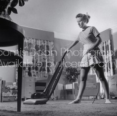 Woman vacuuming.