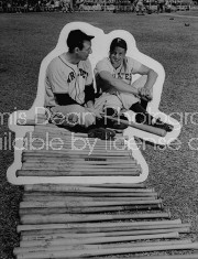 Pittsburg Pirates baseball players Hank Greenberg (L) and Ralph Kiner sitting by row of bats.