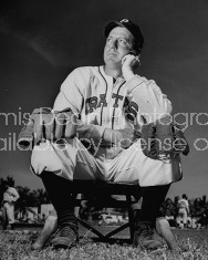 Pirates player sitting on bench and looking into the distance.