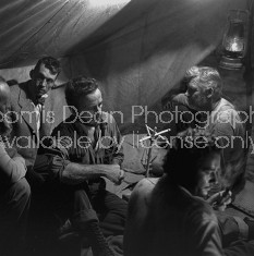 Director of "The Treasure of the Sierra Madre" John Huston (2L) with the film's actors Humphrey Bogart (C) and his father Walter Huston (R) and two unident. others as they talk inside of lamplit tent.