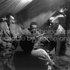Director of "The Treasure of the Sierra Madre" John Huston (L) with the film's actors Humphrey Bogart (C), his father Walter Huston and unident. other as they talk inside of lamplit tent.