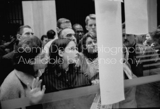 Crowds reading bullentins of John F. Kennedy's assassination outside the US Embassy .