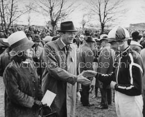 Jockey Pat Taaffe (R), and Gregory Peck and wife (L), talking at the Grand National.